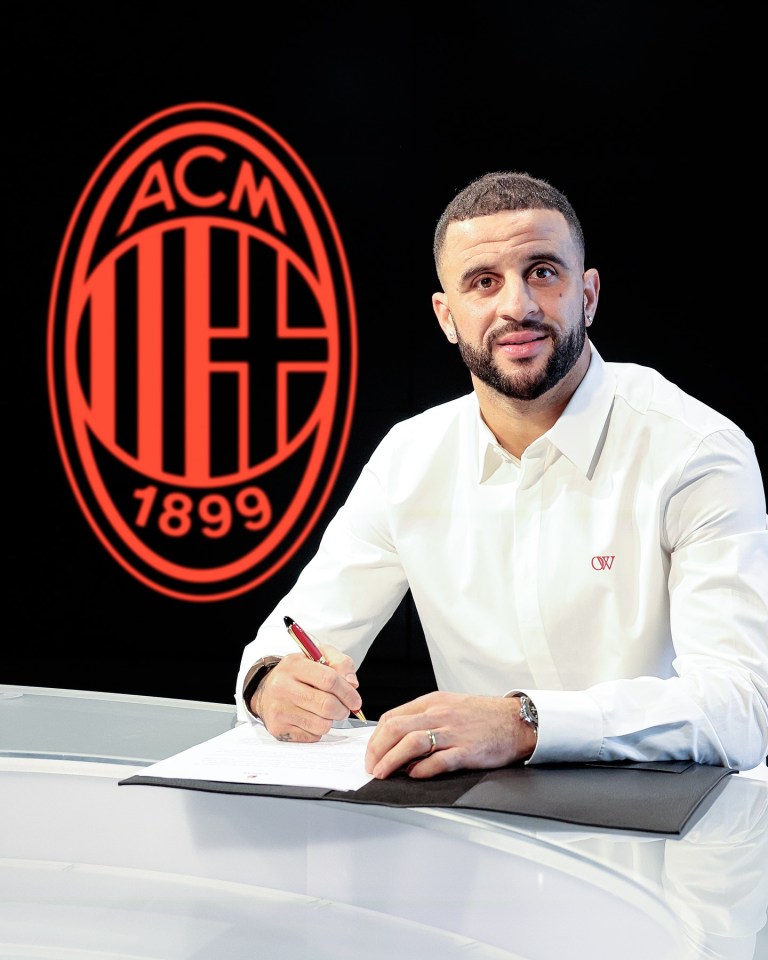 Man signing a document in front of AC Milan logo.