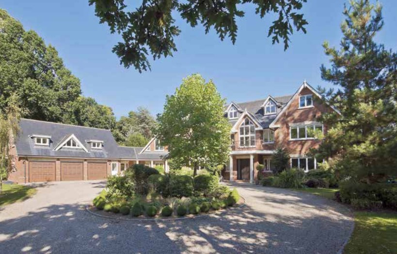 Large brick house with attached garage and circular driveway.