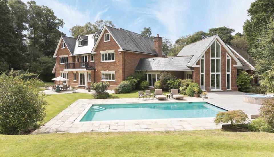 Large brick house with swimming pool and patio.