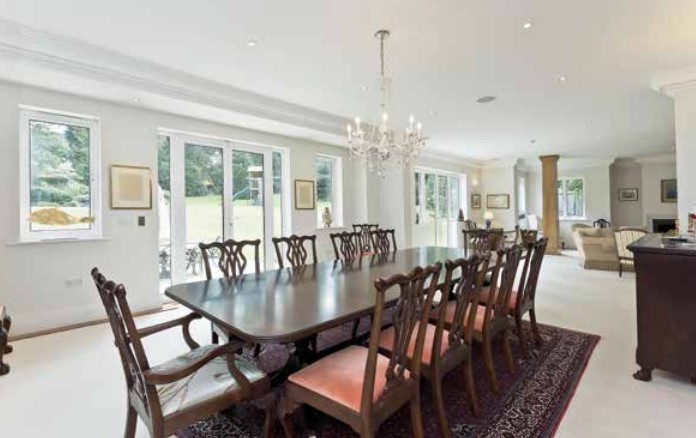 Large dining room with a long wooden table and many chairs.