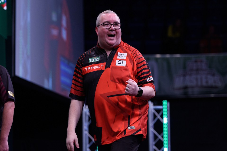 A darts player celebrates a win.