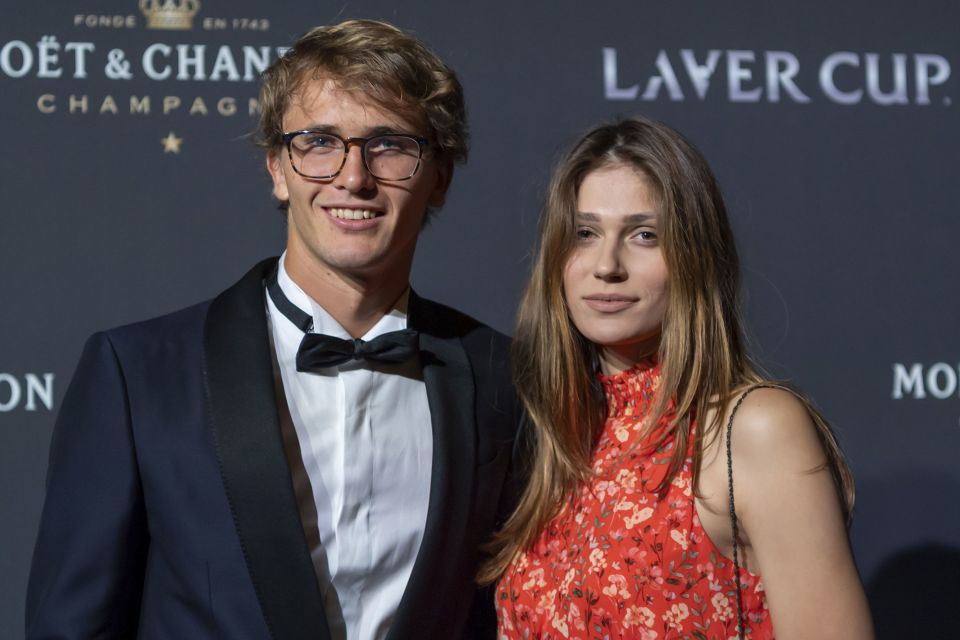 A man in a tuxedo and a woman in a floral dress at the Laver Cup.