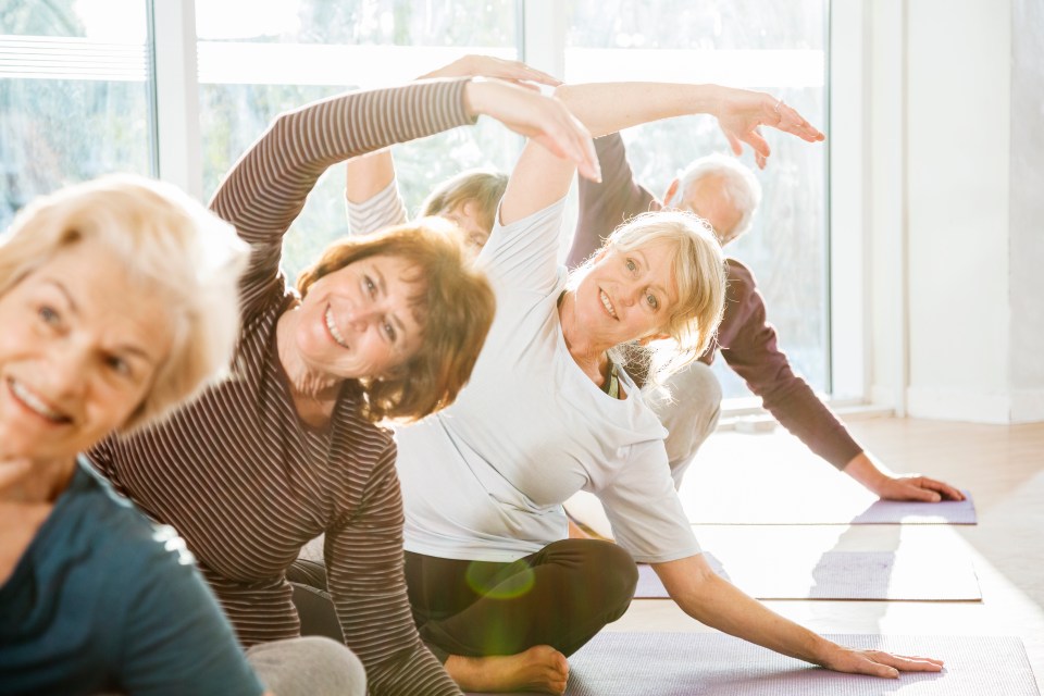 Senior adults participating in a yoga class.