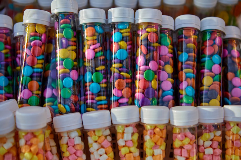 Many small jars of colorful candies.