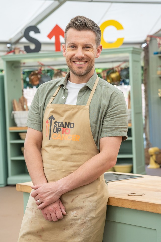 Man wearing a "Stand Up To Cancer" apron.