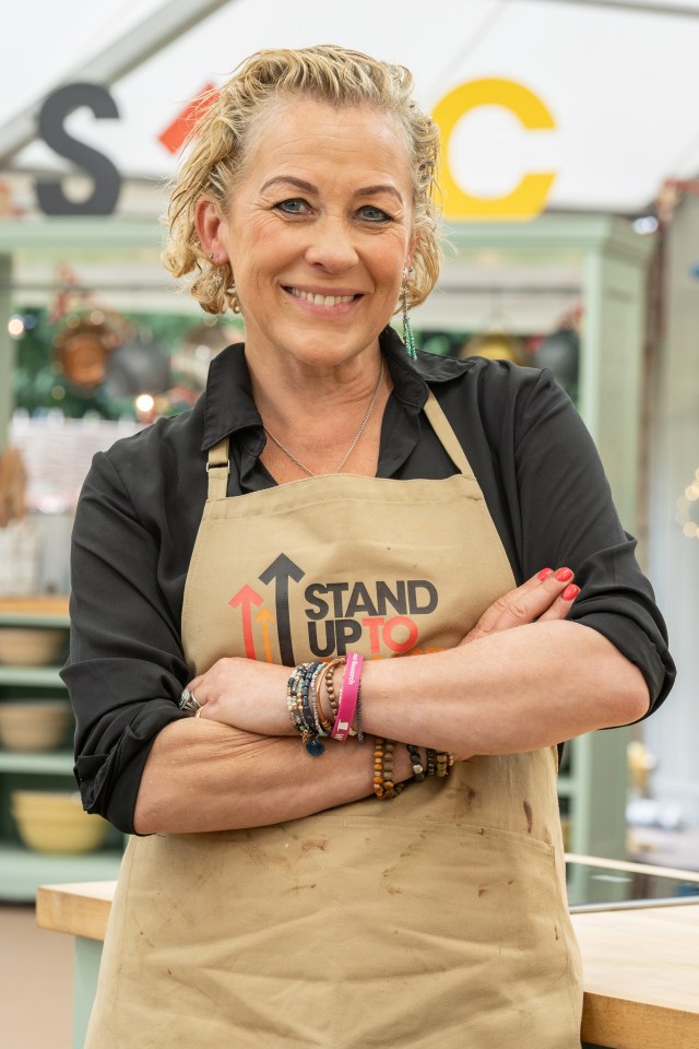 Woman wearing a "Stand Up To Cancer" apron.