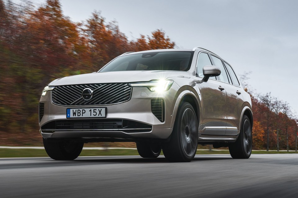 Silver Volvo SUV driving on a road.