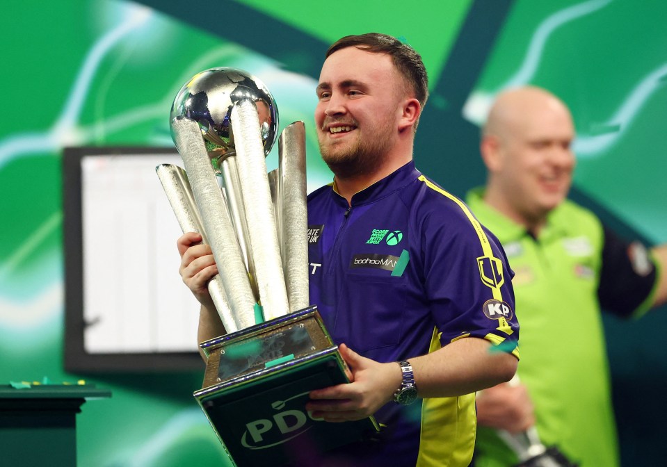 Darts - 2025 PDC World Darts Championship - Alexandra Palace, London, Britain - January 3, 2025 Luke Littler celebrates with the Sid Waddell trophy after winning the 2025 PDC World Darts Championship final against Michael van Gerwen Action Images via Reuters/Andrew Boyers