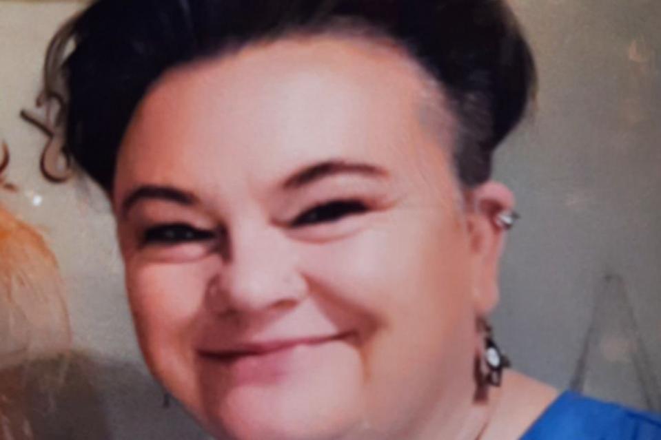 Close-up portrait of a smiling woman.