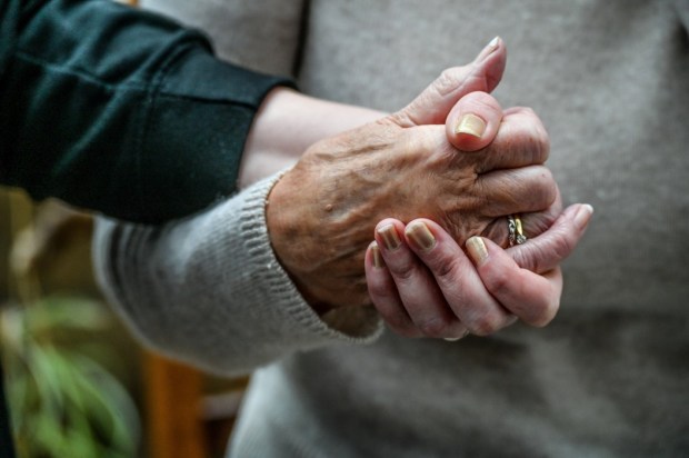 FILE PHOTO - Stock images of pensioner. Old and young hands. Photo released January 7 2025. Six in 10 adults put early signs of dementia down to old age  rather than the condition itself.A poll of 500 people who have a relative or loved one with the condition revealed the common symptoms people often mistake for getting older, when they are in fact all signs of dementia.Misplacing items, needing help with everyday tasks, and problems with judgements and decisions featured on the list.While forgetting things they have just done or been told, and repeating the same question were also confused with ageing. .