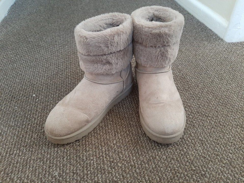 Pair of beige faux fur-lined boots.