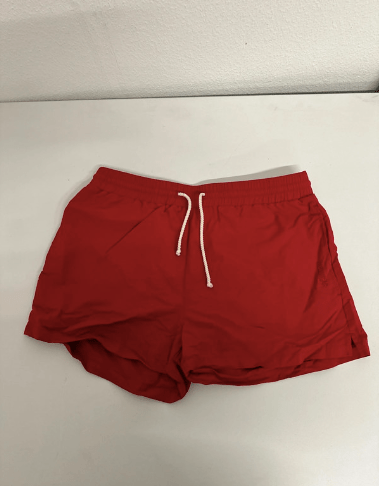 Red swim shorts with drawstring waist.