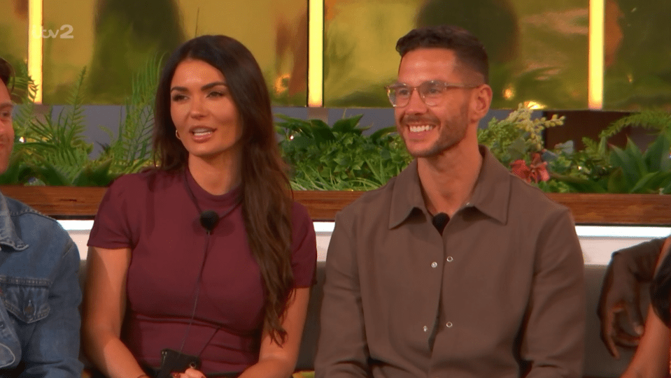 Screenshot of a man and woman sitting together.