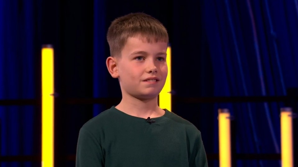 Young boy speaking on stage.