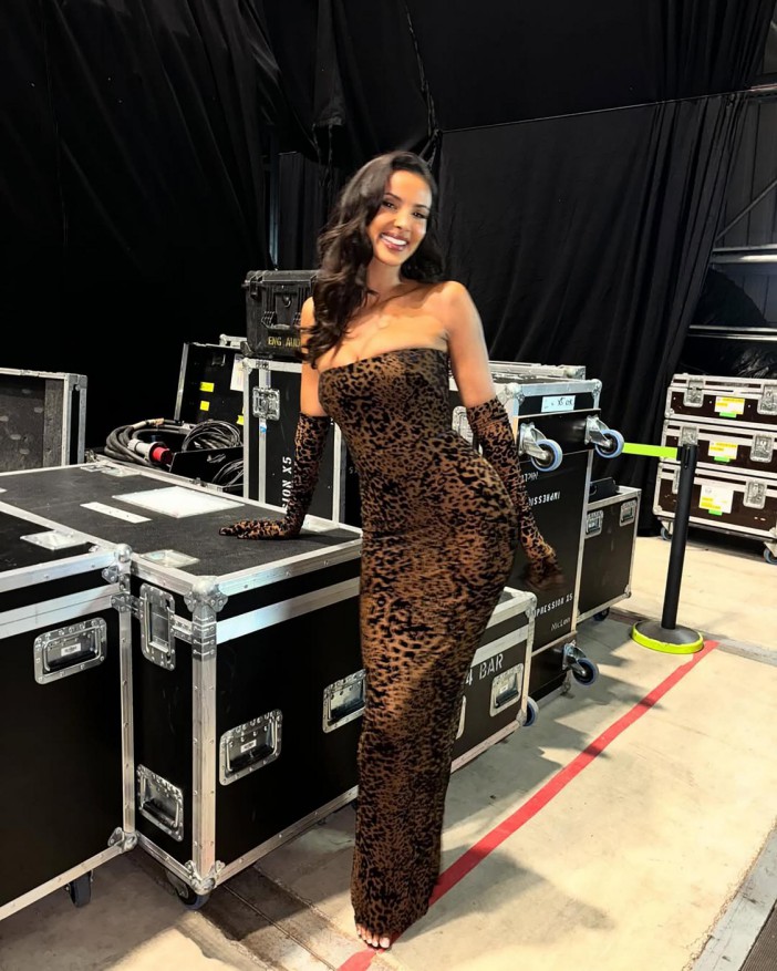 Maya Jama in a leopard print dress backstage.