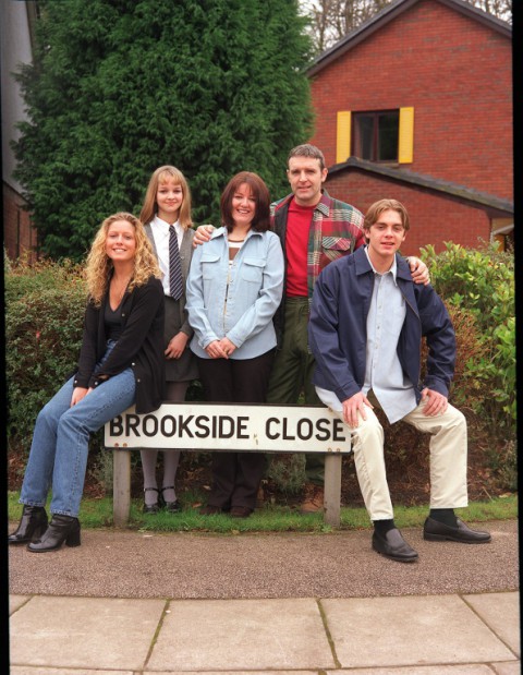 The Shadwick family from Brookside, posing by a Brookside Close sign.