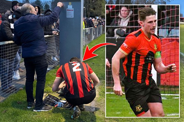 A footballer repairs a post at a soccer game.