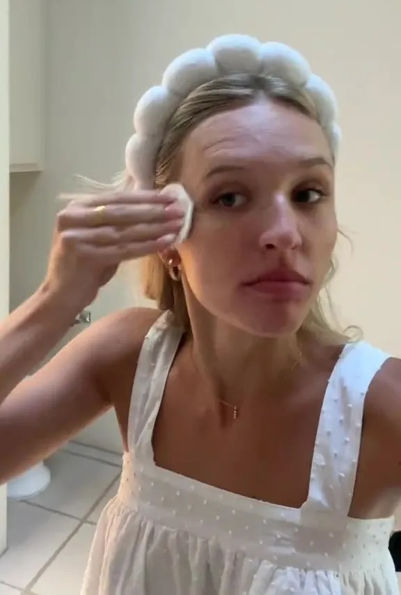 Woman removing her bridal makeup before her wedding.