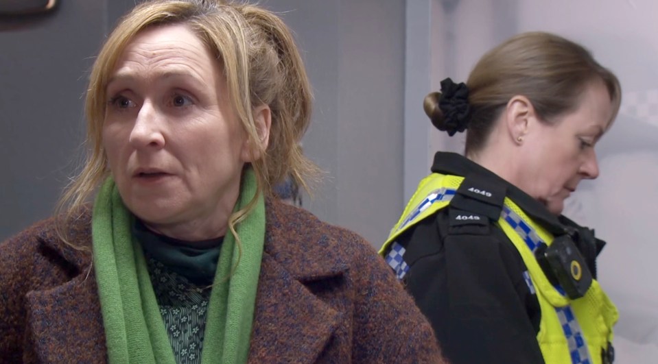 A woman being questioned by a police officer.