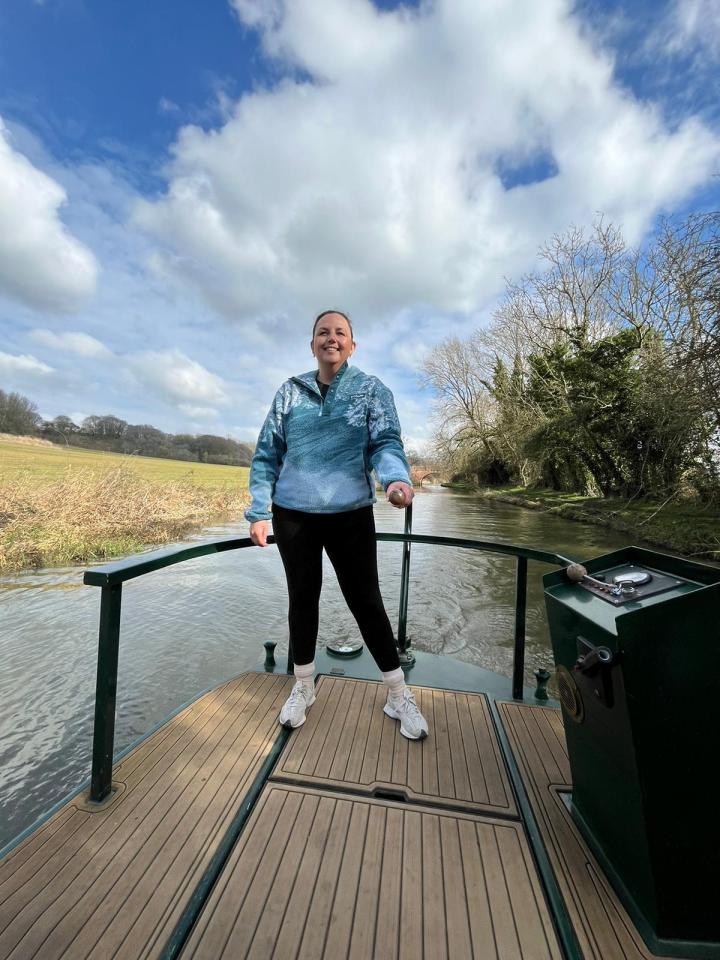 Abby McHale, Deputy Fashion Editor, steering a narrowboat.