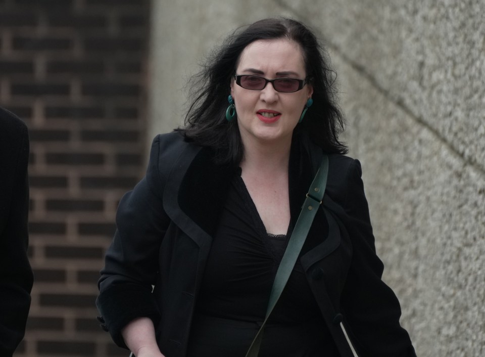 Woman in black coat and sunglasses at a crown court trial.