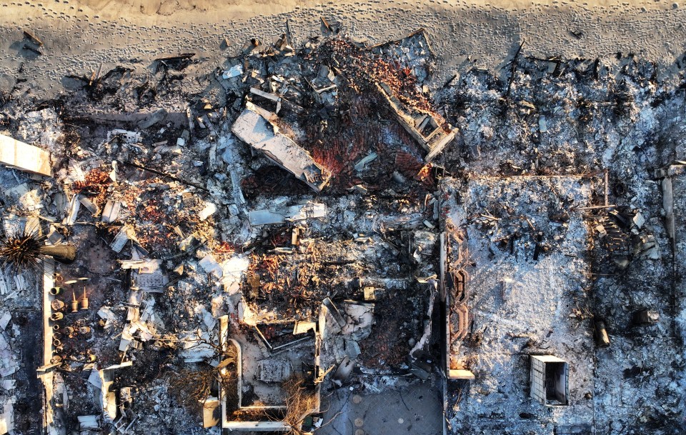 Aerial view of a fire-destroyed beachfront home.