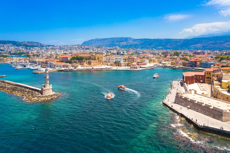 Aerial view of Chania, Crete, showing the harbor, lighthouse, and old town.