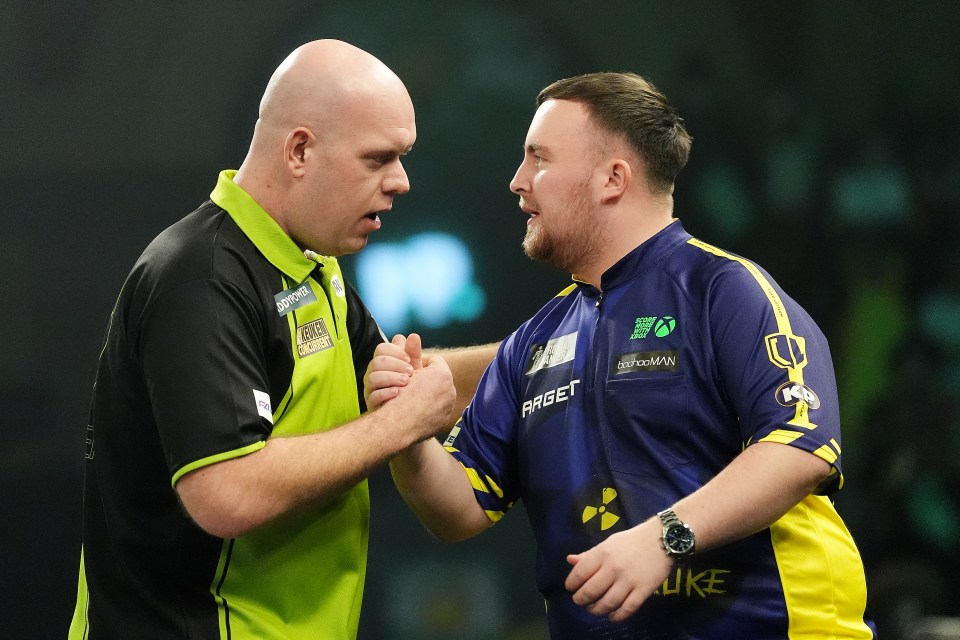 Michael van Gerwen and Luke Littler shake hands before a darts championship final.