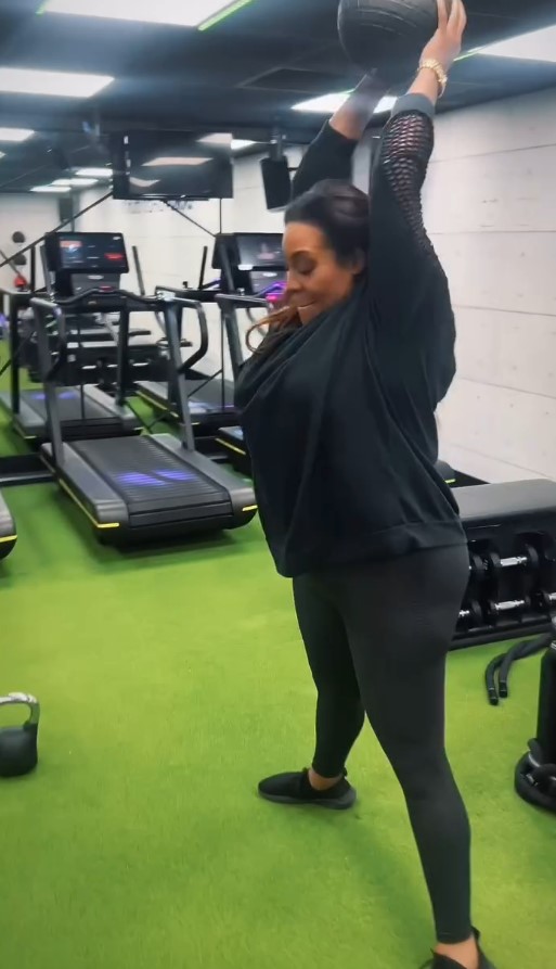 Woman doing a medicine ball exercise in a gym.