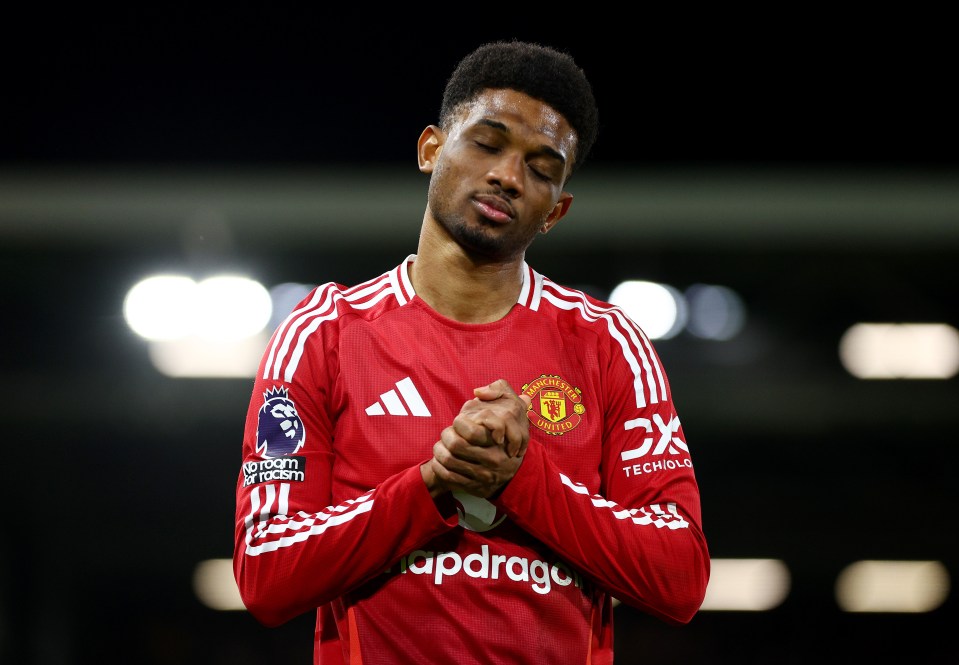 Amad Diallo of Manchester United in a red jersey with hands clasped.