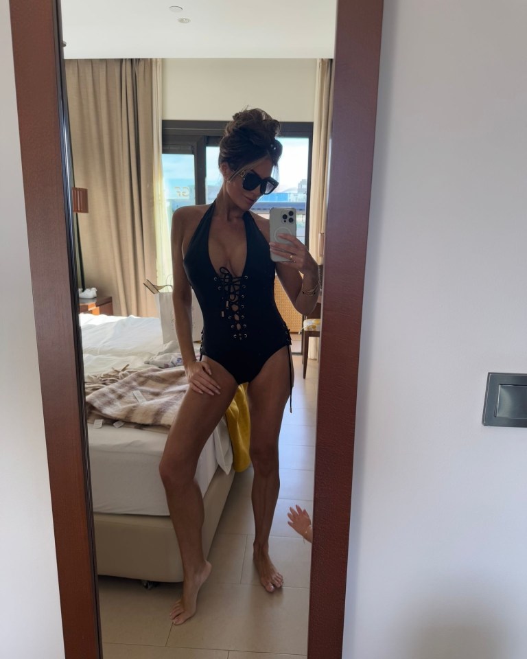 Amy looked stunning in a black swimsuit on her post-Christmas holiday