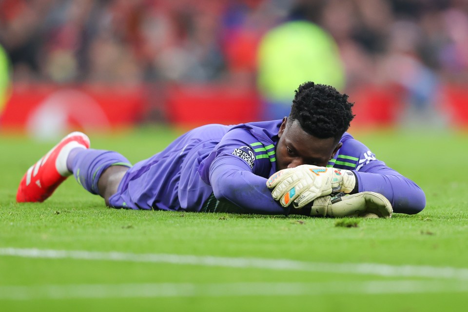 Andre Onana of Manchester United lying on the field after a goal.