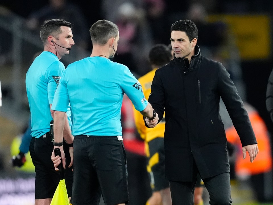 Mikel Arteta shaking hands with a referee.