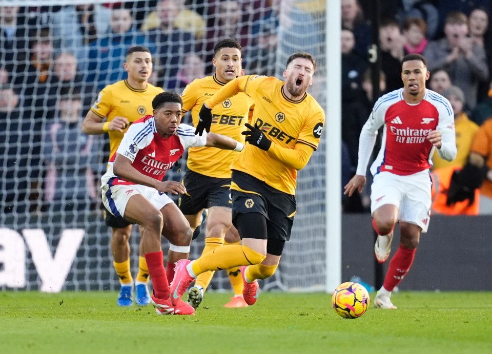 Arsenal's Myles Lewis-Skelly fouling Wolverhampton Wanderers' Matt Doherty.