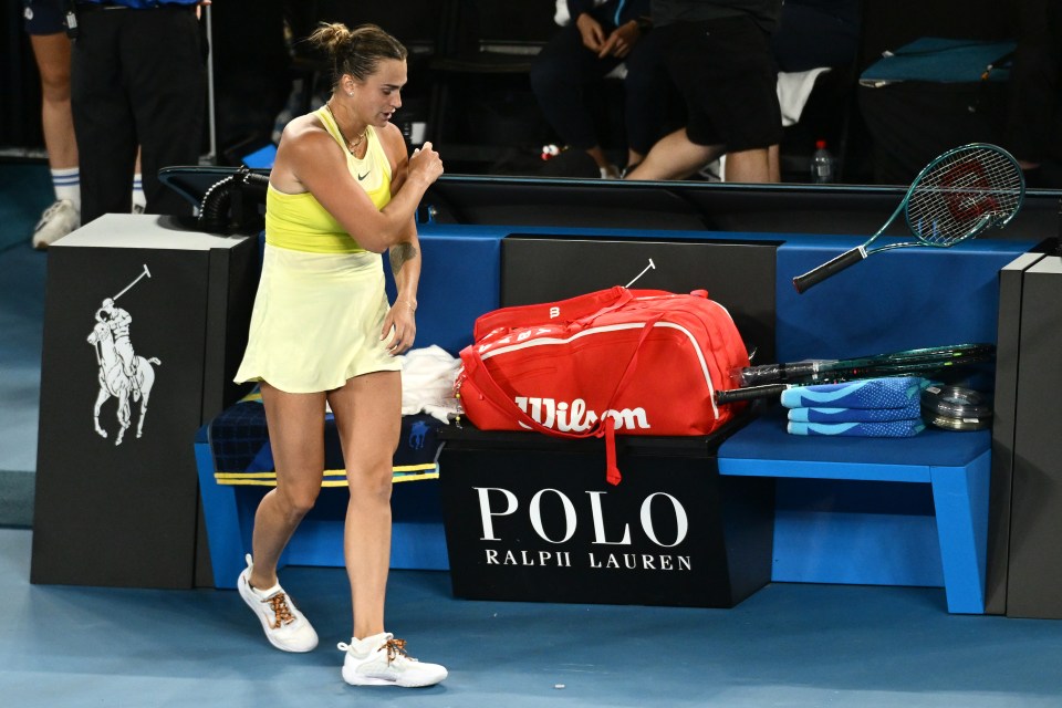 Aryna Sabalenka throws her broken tennis racket after losing a match.