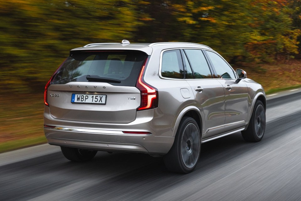 Silver Volvo SUV driving on a road.