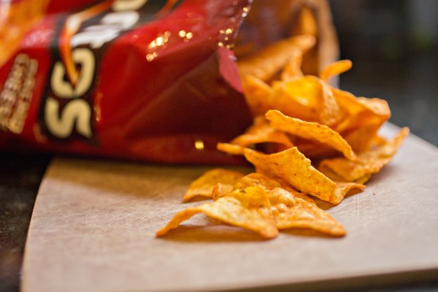 Doritos chips spilling from a bag.