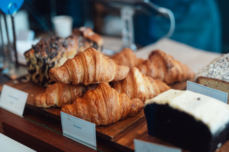 Croissants and other pastries on display in a cafe.