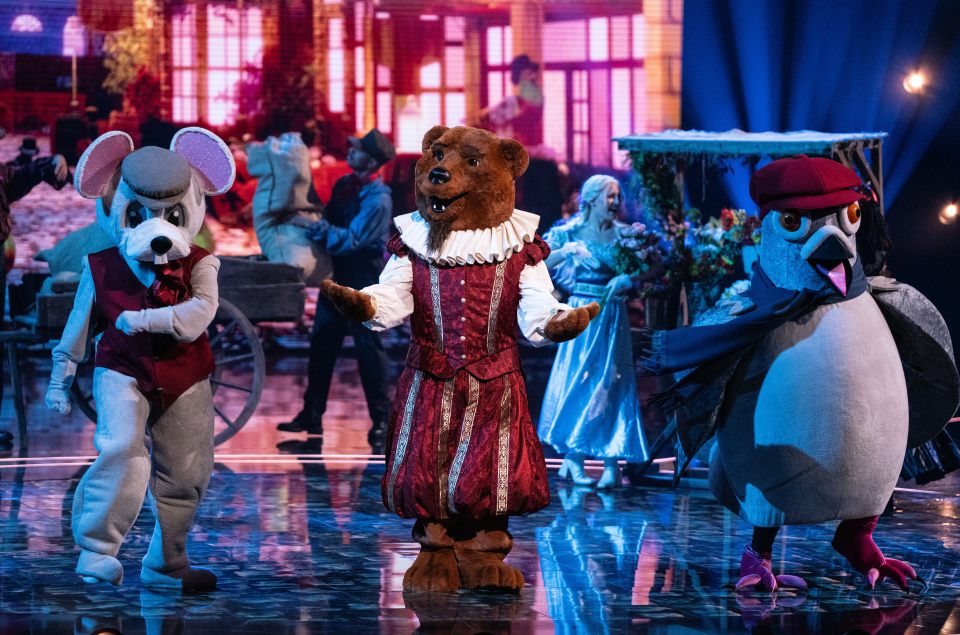 Three costumed performers, a mouse, bear, and pigeon, on a stage.