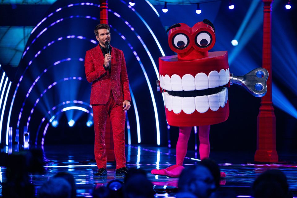 Joel Dommett and Teeth, a contestant on The Masked Singer.