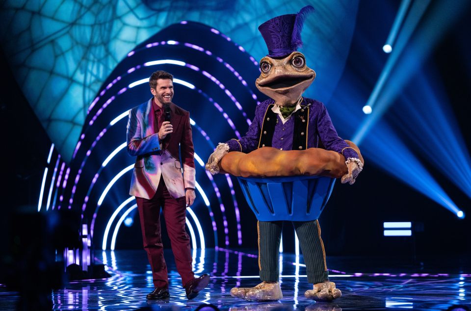 Joel Dommett and Toad, a contestant on The Masked Singer, on stage.