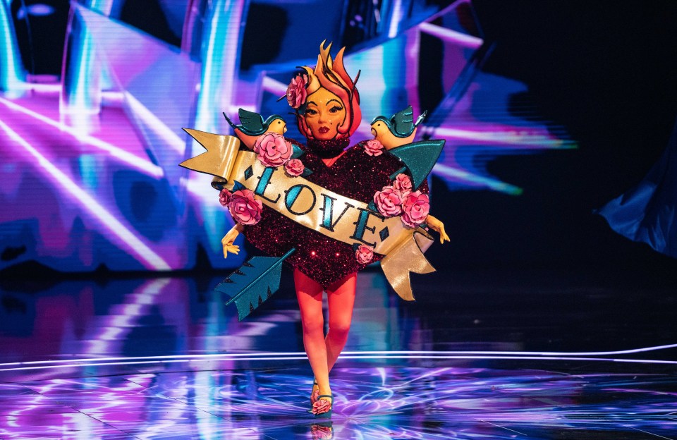 Contestant in a heart-shaped tattoo costume on The Masked Singer.