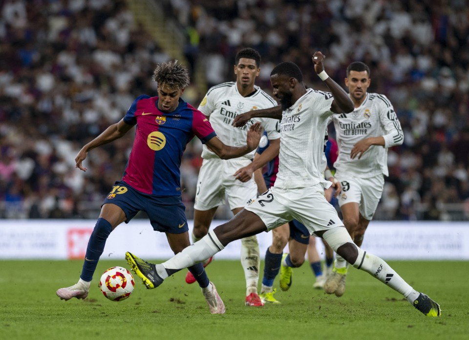 Soccer players from Barcelona and Real Madrid vying for the ball.