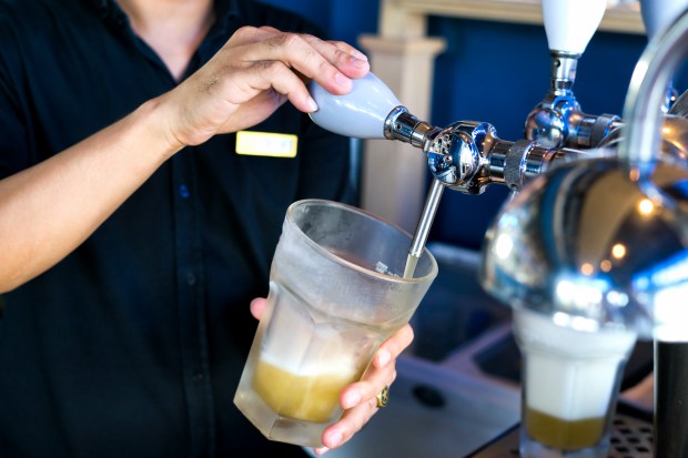 Bartender pouring lager beer.