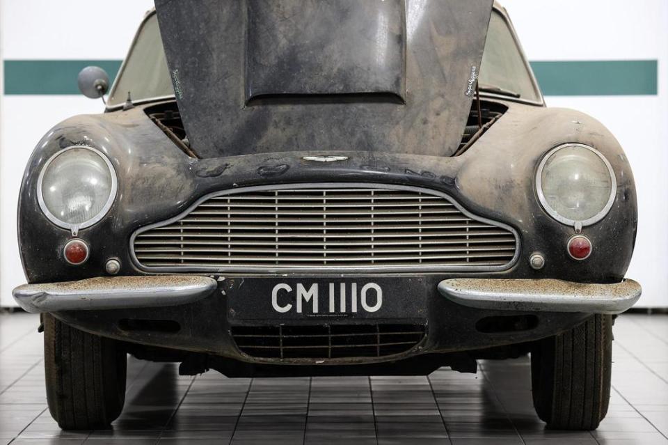 Dusty Aston Martin DB6 with hood open.