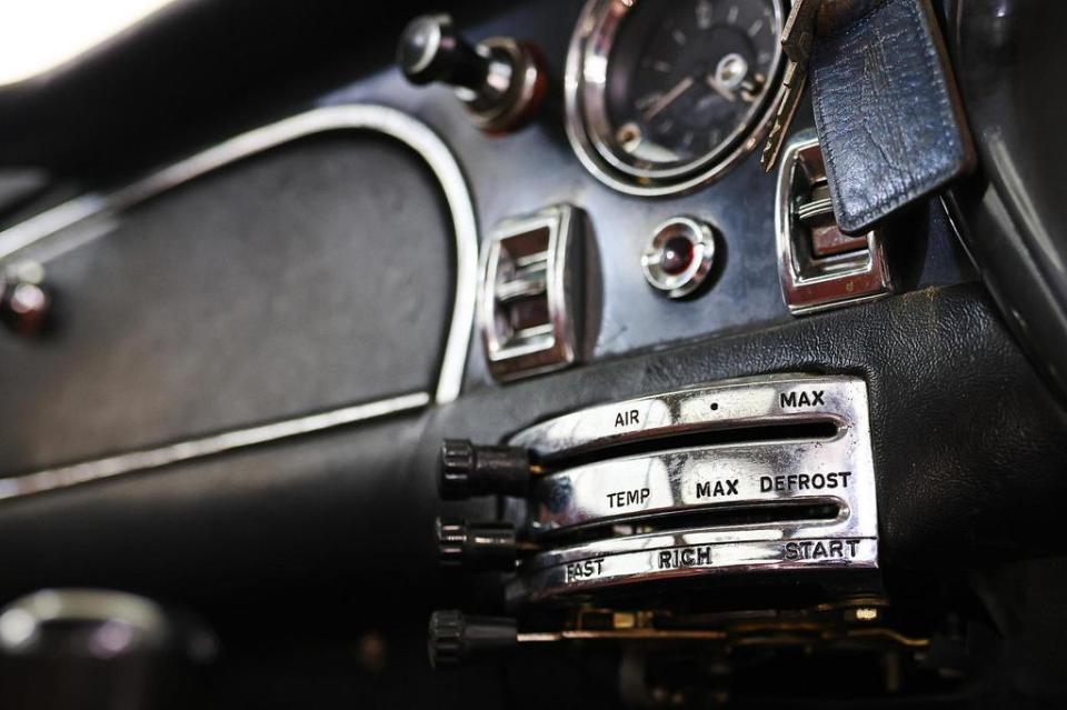 Close-up of an Aston Martin DB6's dashboard controls.