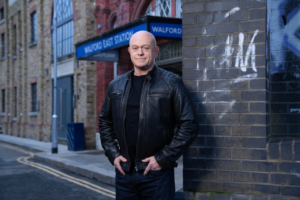 Ross Kemp, reprising his role as Grant Mitchell in Eastenders, stands outside Walford East Station.