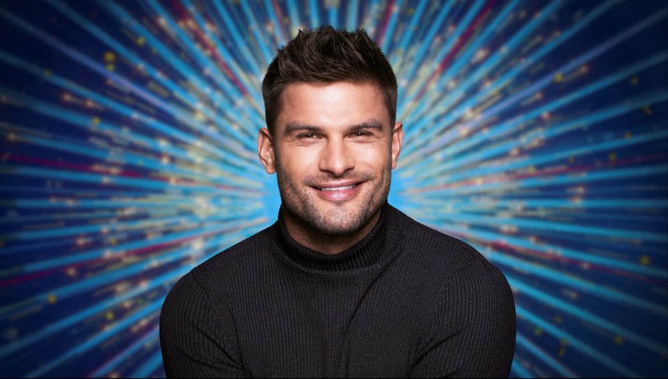 Aljaz Skorjanec, professional dancer, in front of a sparkly background.