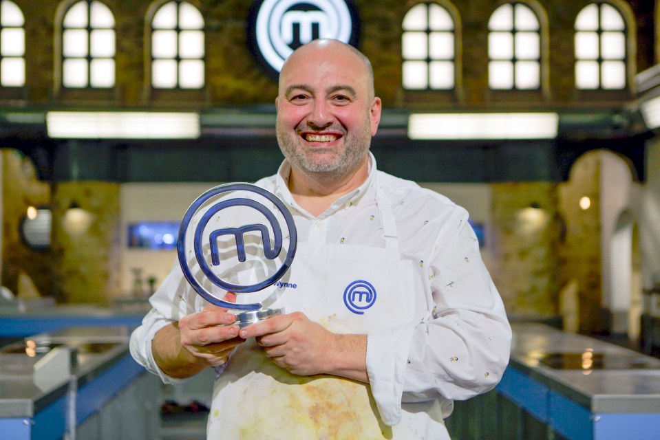 Wynne Evans, winner of Celebrity MasterChef 2023, holding the trophy.