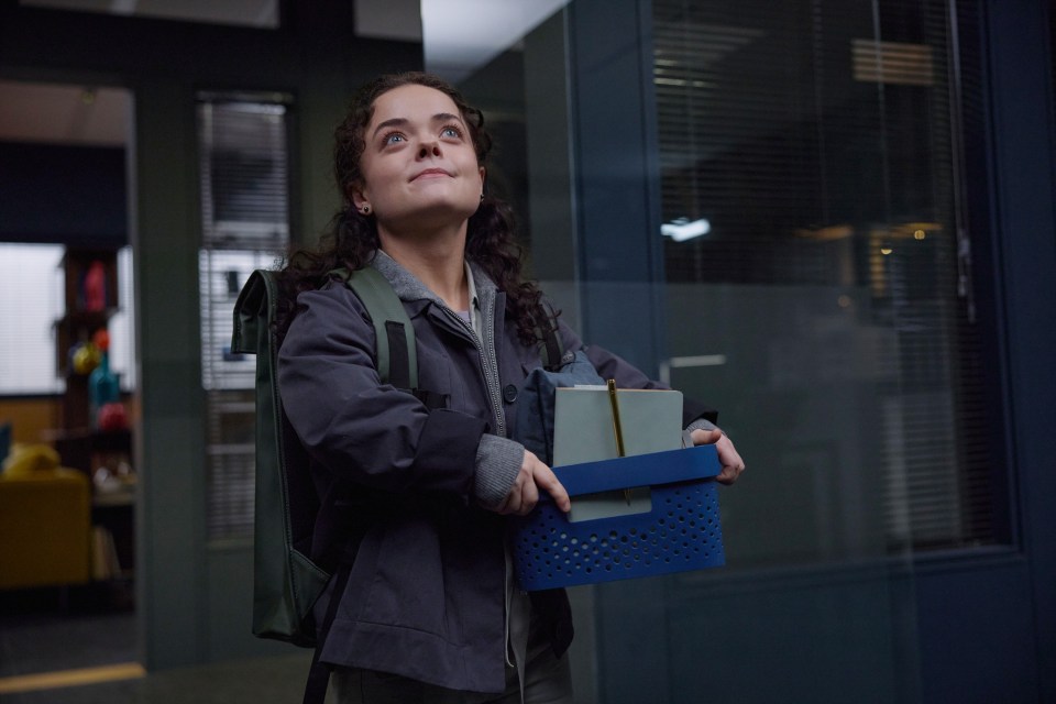 Francesca Mills as Kit Brooks in Silent Witness, carrying a box of belongings.